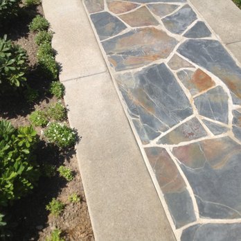 Cypress Landscaping - a stone walkway in a garden - Landscaping Near Me