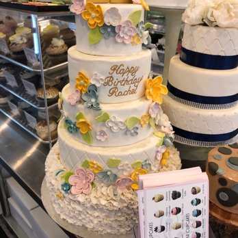 Happycakes - a three tiered white cake with blue and yellow flowers - Desserts Near Me - Surrey, British Columbia