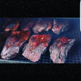 Top Notch BBQ - meat cooking on a grill - Food Trucks Near Me - Fulshear, Texas