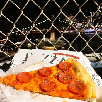 Front Street Pizza - Enjoying a pepperoni Pizza Slice - Pizza Near Me - Brooklyn, New York Front Street Pizza - Enjoying a pepperoni Pizza Slice - Pizza Near Me - Brooklyn, New York
