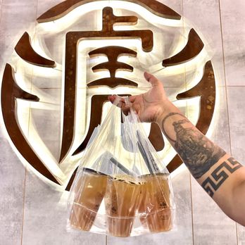 Tiger Sugar - a person holding a bag of donuts - Bubble Tea Near Me - Ottawa, Ontario