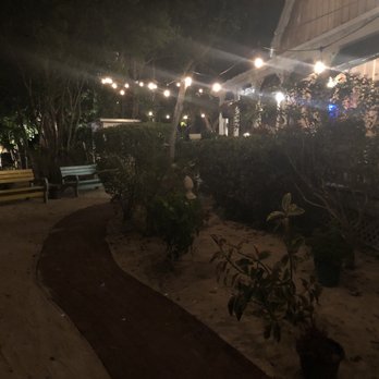 Key Largo Conch House - Walking up the path to conch house lit by cool lights - Seafood Near Me - Key Largo, Florida
