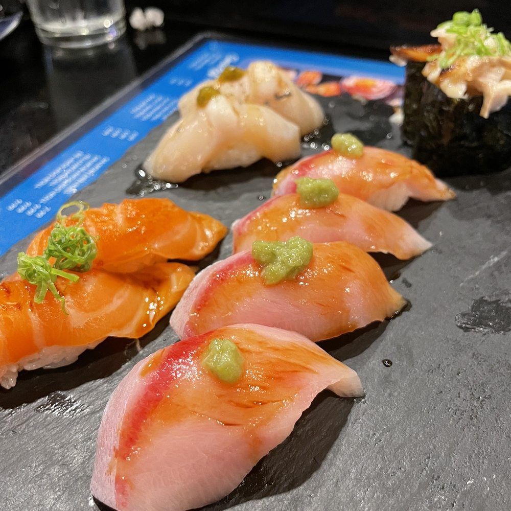 DAI Sushi - Yellowtail Nigiri (front right), salmon nigiri (left front), Japanese scallop (left back), miso cod nigiri (right back) - Japanese Near Me - Westminster, California DAI Sushi - Yellowtail Nigiri (front right), salmon nigiri (left front), Japanese scallop (left back), miso cod nigiri (right back) - Japanese Near Me - Westminster, California
