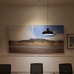 Field Colony - Tim Daly's painting 'Sundog with Aurora Contrails Near Abiquiu' hanging in Field Colony.