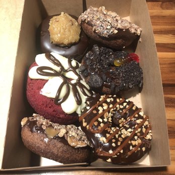 Hurts Donut - A little dirty comprised of 2 Twix, 1 red velvet, 1 snickers, 1 German chocolate & 1 dirty worm. Too sweet for me! - Donuts Near Me - Tempe, Arizona