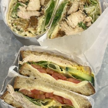 DeLuca's Market - Turkey on sourdough with cheese, cucumber, lettuce, tomato, mustard & mayo. Chicken Caesar wrap. - Grocery Near Me - Boston, Massachusetts