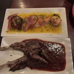 Lamb Chops - A plate with three scallops wrapped in prosciutto and topped with herbs, served with a yellow sauce. Another plate features a cooked lamb chop with sauce on a white rectangular dish.