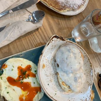 First Watch - Biscuit and Turkey gravy with seasoned potatoes and two eggs (over easy). Multigrain carrot cake and pecan pancake (1). - Breakfast & Brunch Near Me - Rogers, Arkansas
