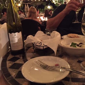 Zaytoon - Sharing a bottle of Ksara while enjoying warm bread, humos and the best Lebneh with olives. - Lebanese Near Me - Santa Barbara, California Zaytoon - Sharing a bottle of Ksara while enjoying warm bread, humos and the best Lebneh with olives. - Lebanese Near Me - Santa Barbara, California