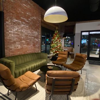 The Pines Downtown - a living room with a christmas tree in the background - Bars Near Me - Sevierville, Tennessee The Pines Downtown - a living room with a christmas tree in the background - Bars Near Me - Sevierville, Tennessee
