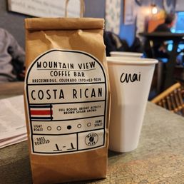 Chai latte and a bag of Costa Rican beans to brew at home Chai latte and a bag of Costa Rican beans to brew at home
