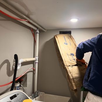 A P S - Inserting the insulation in the hole on the internal wall of the laundry room. - Painters Near Me