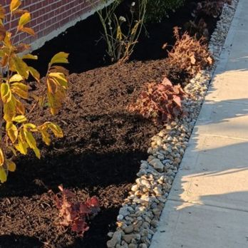 Samson Lawncare - a front yard with a gravel bed - Lawn Services Near Me