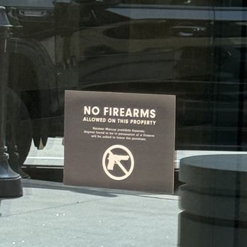 Neiman Marcus - A photo of a sign outside their door, telling the good guys not to protect themselves - Accessories Near Me - Fort Worth, Texas