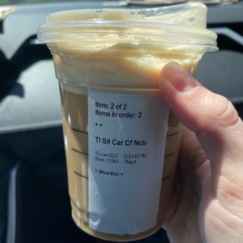 Starbucks - a hand holding a cup of iced coffee - Coffee & Tea Near Me - Fort Wayne, Indiana