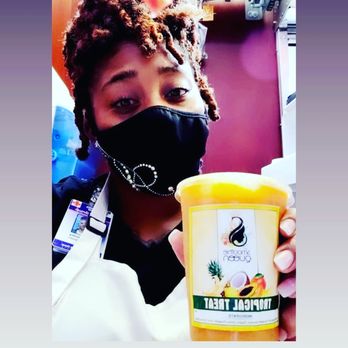 Smoothie Queen - a woman wearing a face mask and holding a cup of smoothie - Food Delivery Services Near Me Smoothie Queen - a woman wearing a face mask and holding a cup of smoothie - Food Delivery Services Near Me