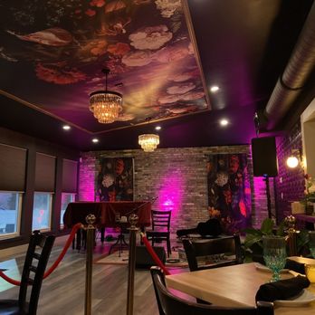 Chez L'Amour - a dining room with purple lighting - Tapas/Small Plates Near Me - St. Augustine, Florida