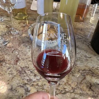 Grande River Vineyards - Looking at the color of a red wine sample. - Wine Tours Near Me - Palisade, Colorado Grande River Vineyards - Looking at the color of a red wine sample. - Wine Tours Near Me - Palisade, Colorado