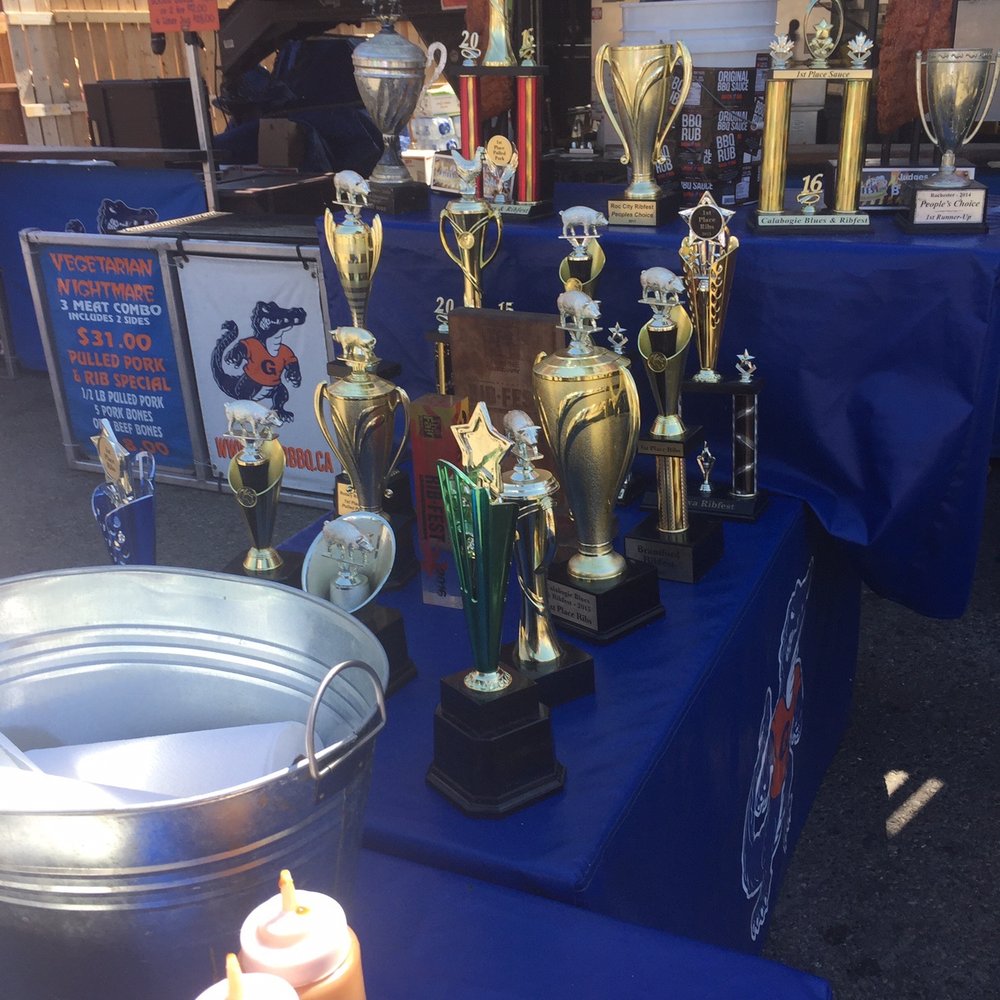 Gator Bbq - trophies and condiments on a table - Food Stands Near Me - Calgary, Alberta Gator Bbq - trophies and condiments on a table - Food Stands Near Me - Calgary, Alberta