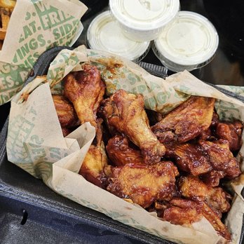 Wingstop - BBQ wings - Fried chicken wings served in a basket with dipping sauces and vegetable sticks, typical of casual dining at Wingstop. - Chicken Wings Near Me - Springfield, Oregon