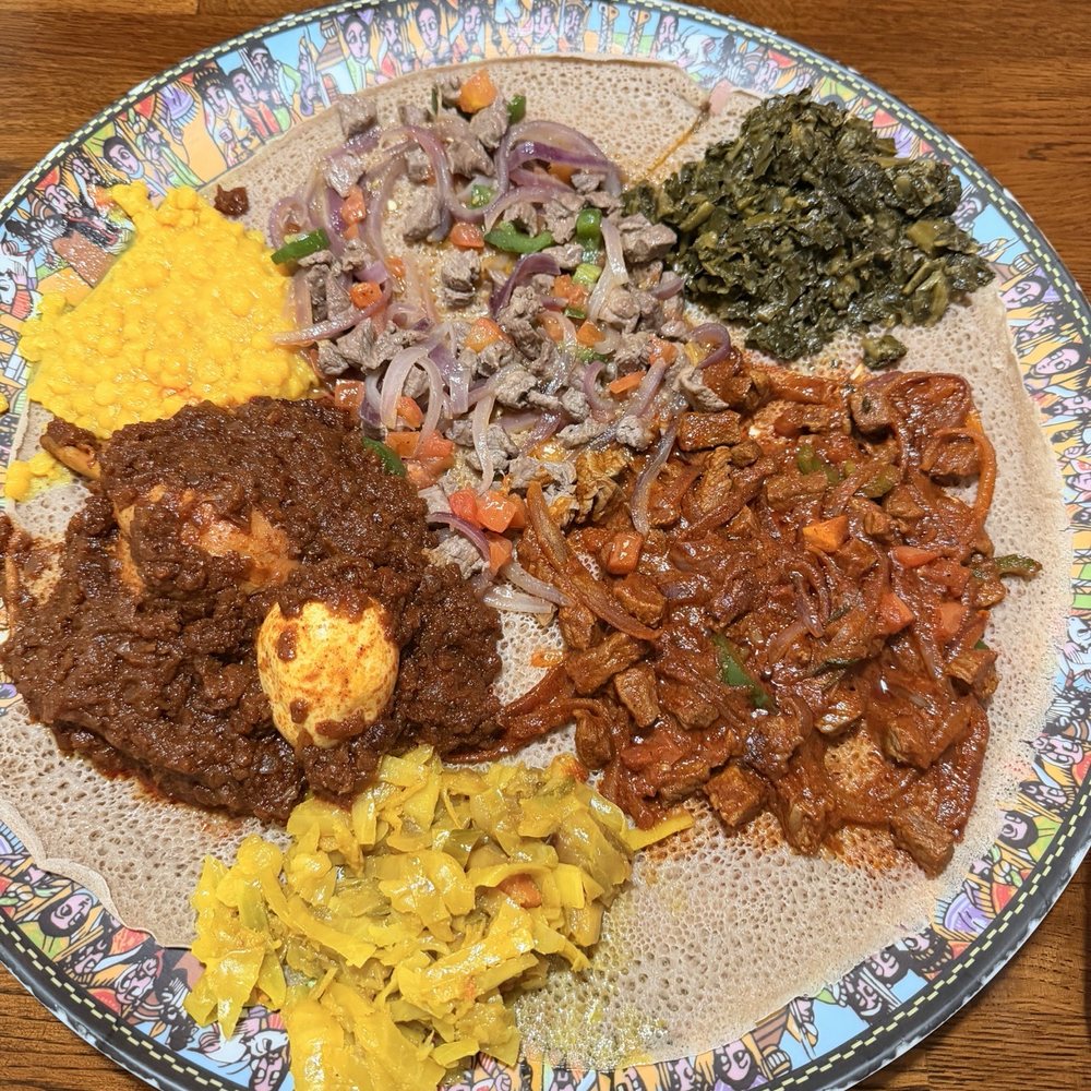 Doro wat, yellow split peas, lamb tibs, collard greens, awaze tibs and cabbage with carrots. Doro wat, yellow split peas, lamb tibs, collard greens, awaze tibs and cabbage with carrots.