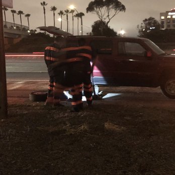 Hadley Tow - 4 men from a Hadley tow company trying to figure out how to change a simple tire - Towing Near Me - Costa Mesa, California