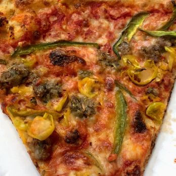 Northeast Pizza - Slice of Italian pizza with a bite taken (he couldn't wait) - Pizza Near Me - Kansas City, Missouri Northeast Pizza - Slice of Italian pizza with a bite taken (he couldn't wait) - Pizza Near Me - Kansas City, Missouri