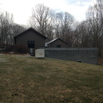 Tomorrow's Architecture - New modern private home looking at Garage and Retaining wall containing an interior parking court. - Architects Near Me - Lagrangeville, New York Tomorrow's Architecture - New modern private home looking at Garage and Retaining wall containing an interior parking court. - Architects Near Me - Lagrangeville, New York
