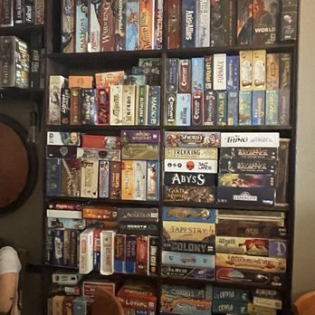 Knight Moves Cafe - sweet board game library! (this is just one wall of many) - Cafes Near Me - Brookline, Massachusetts