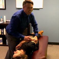 Optimal Wellness & Chiropractic - Happy side poster adjusting in Austin. HA