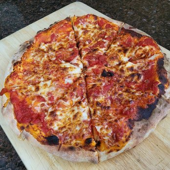Don Jono's Pizzeria - a pizza on a cutting board - Pizza Near Me - Smithtown, New York