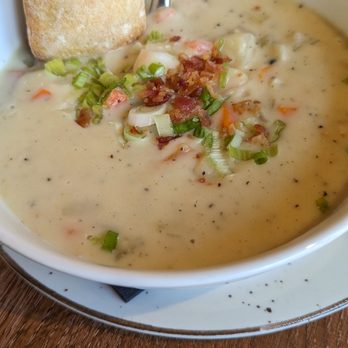 The Cliff House - Clamcowder featured with a piece of bread. - Canadian (New) Near Me - North Vancouver, British Columbia The Cliff House - Clamcowder featured with a piece of bread. - Canadian (New) Near Me - North Vancouver, British Columbia