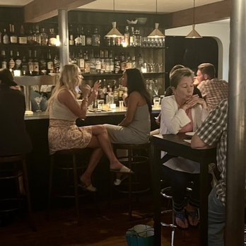 Drifters - a group of people sitting at a bar - Cocktail Bars Near Me - South Chatham, Massachusetts