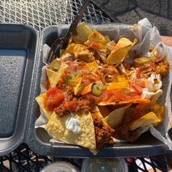 Summer Sno - Nacho supreme. Loaded with meat sauce cheese chips and on the side she gives sour cream salsa and jalapeños. Very fresh.