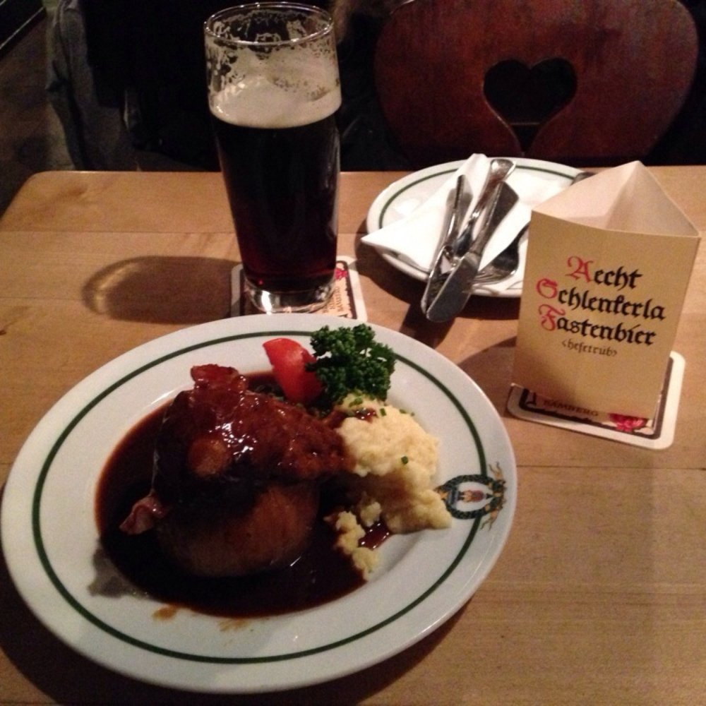 Schlenkerla - Bamberger Zwiebel : onion stuffed with a meatloaf of sorts. Topped with gravy and bacon. - German Near Me - Bamberg, BY Schlenkerla - Bamberger Zwiebel : onion stuffed with a meatloaf of sorts. Topped with gravy and bacon. - German Near Me - Bamberg, BY