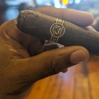 Heights Cigar Lounge - a hand holding a cigar - Tobacco Shops Near Me - Houston, Texas