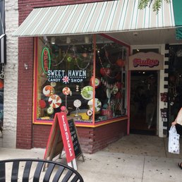 a woman walking past a storefront a woman walking past a storefront