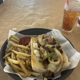 Philly steak sandwich and fries