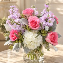 Flowers by Valli & Events - Pink roses, white hydrangea, and soft lavender clusters arranged with silvery foliage in a clear glass vase-romantic, pastel garden-style bo