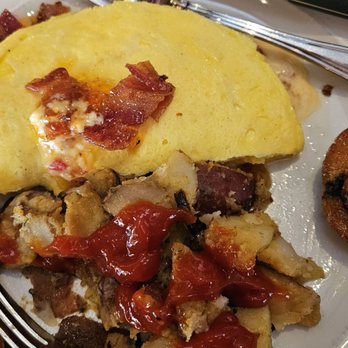 Village Tavern - Tavern Omelet with pimento cheese bacon and potatoes, and a blueberry muffin - New American Near Me - Greensboro, North Carolina Village Tavern - Tavern Omelet with pimento cheese bacon and potatoes, and a blueberry muffin - New American Near Me - Greensboro, North Carolina