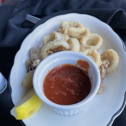 Calamari. The tomato sauce dip. I should have kept it for my pasta if I knew they would charge me for extra sauce! Lol Calamari. The tomato sauce dip. I should have kept it for my pasta if I knew they would charge me for extra sauce! Lol