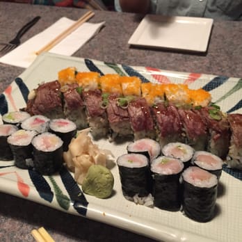 Sushi Kuni - Front to back: two yellowtail rolls, Choi's roll, Boston roll - Japanese Near Me - Grand Rapids, Michigan Sushi Kuni - Front to back: two yellowtail rolls, Choi's roll, Boston roll - Japanese Near Me - Grand Rapids, Michigan