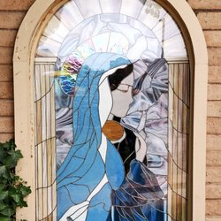 St Germaine Catholic Church - A stained-glass design representing the Blessed Virgin Mary holding the baby Jesus.