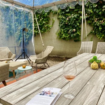 Picayune Cellars & Mercantile - a table with a glass of wine on it - Wine Tasting Room Near Me - Calistoga, California