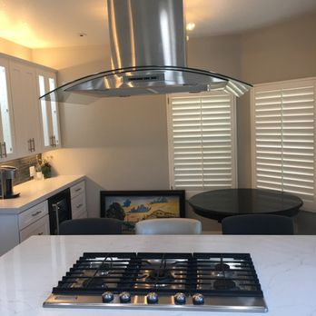 Millenium Tile & Marble - a kitchen island with a stovetop - General Contractors Near Me - Anaheim, California