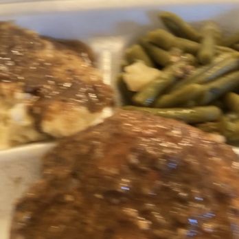 Jim & Samella's - Smothered pork chops  just look at the seasoning in the gravy - Soul Food Near Me - Memphis, Tennessee