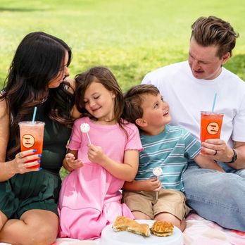 Ziggi's Coffee - Family on a picnic blanket enjoying iced Ziggi's drinks and cake pops in a park. - Coffee & Tea Near Me - Eaton, Colorado Ziggi's Coffee - Family on a picnic blanket enjoying iced Ziggi's drinks and cake pops in a park. - Coffee & Tea Near Me - Eaton, Colorado