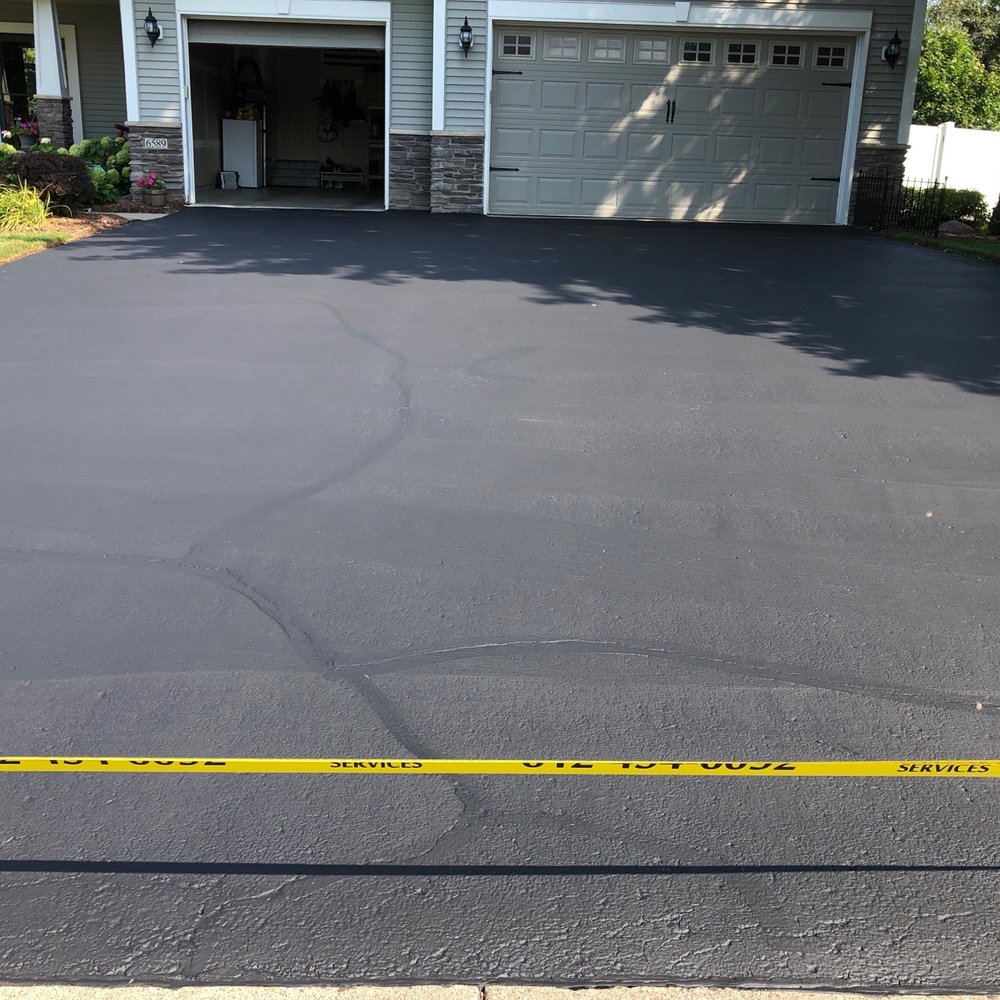 Supercare Driveway Services - a driveway with yellow tape - General Contractors Near Me - Burnsville, Minnesota Supercare Driveway Services - a driveway with yellow tape - General Contractors Near Me - Burnsville, Minnesota