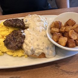 Scrambled eggs, sausage, sausage gravy on biscuits, country potatoes
