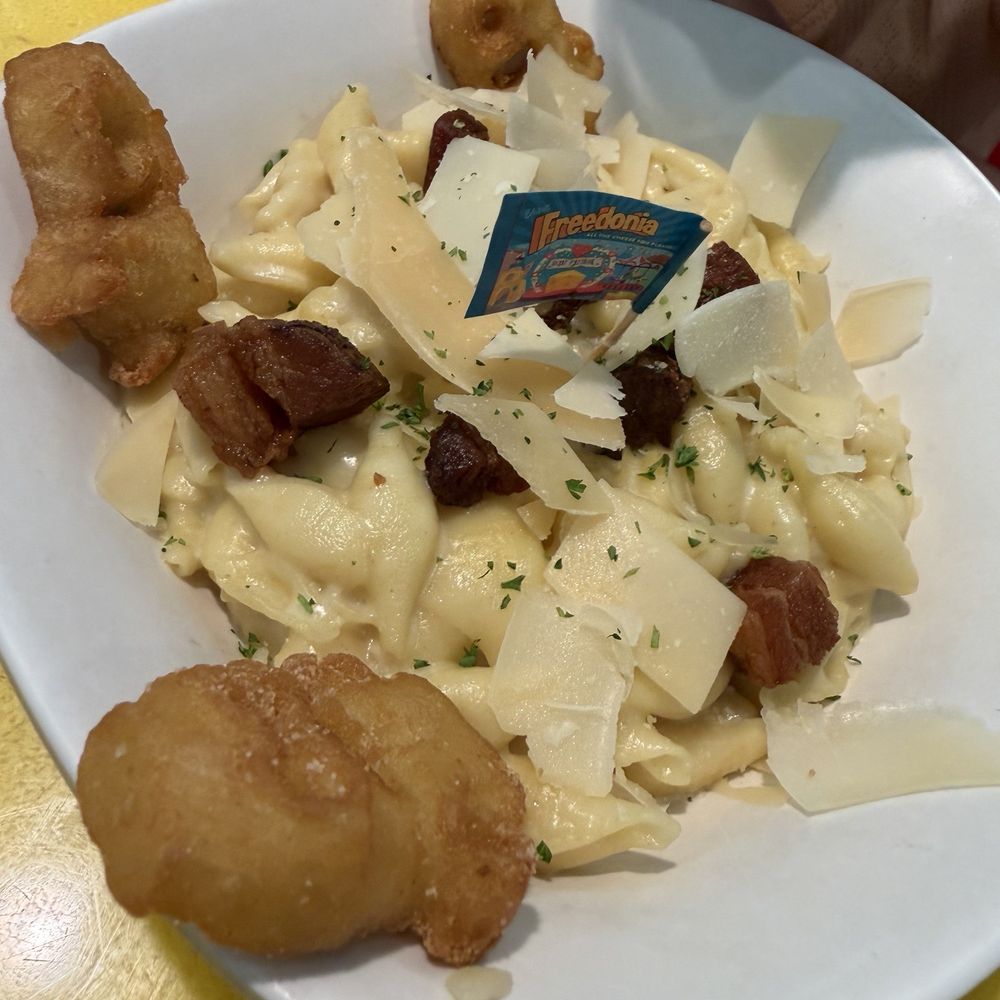 Illumination’s Minion Cafe - This Mac n cheese with pork belly bites was the best thing we tried I'm not sure why it comes with minion tots - New American Near Me - Orlando, Florida Illumination’s Minion Cafe - This Mac n cheese with pork belly bites was the best thing we tried I'm not sure why it comes with minion tots - New American Near Me - Orlando, Florida